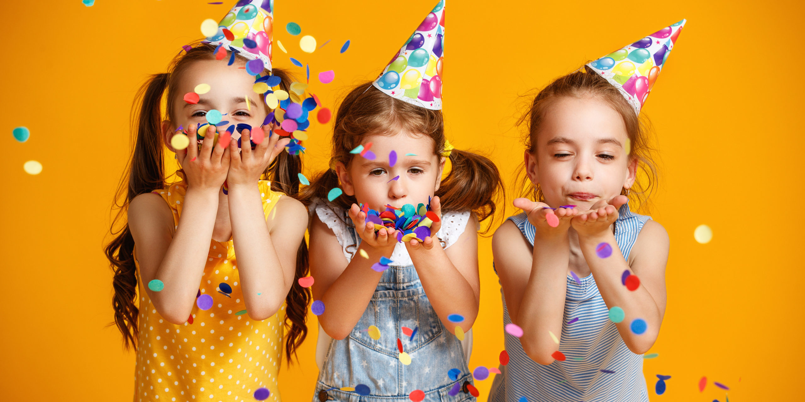 Happy,Birthday,Children,Girls,With,Confetti,On,Colored,Yellow,Background